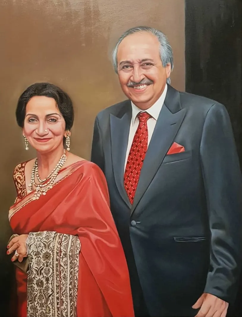 Oil portrait of a couple, he in a dark suit and she in a red sari, painted by hand on canvas